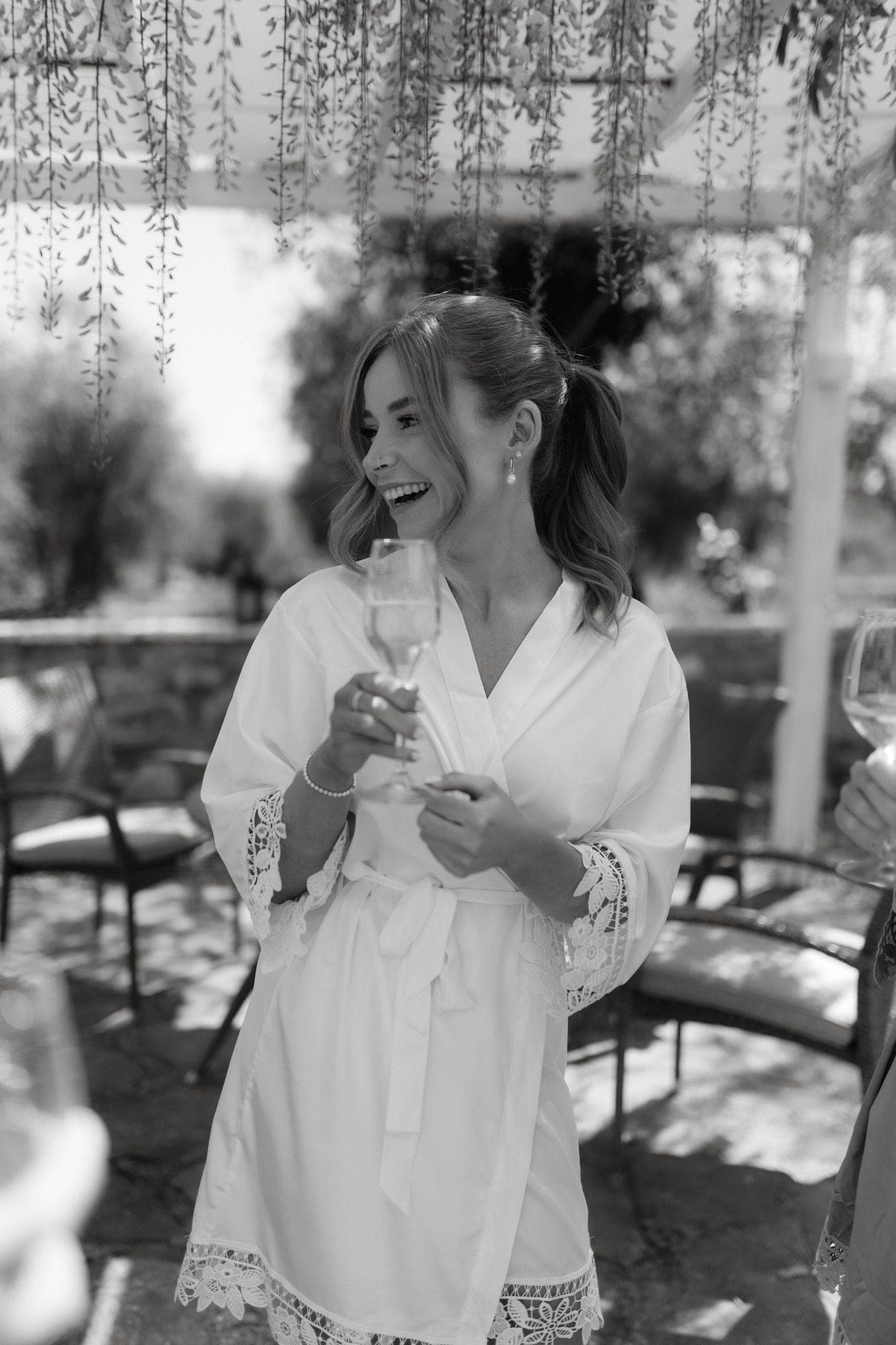Bride in her robe with champagne on the wedding morning